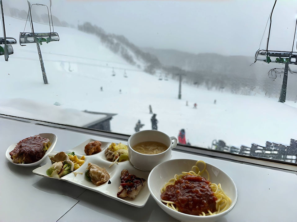 Lunch at the Annupuri ski resort restaurant window, with a view of the snowy slopes and gondola outside